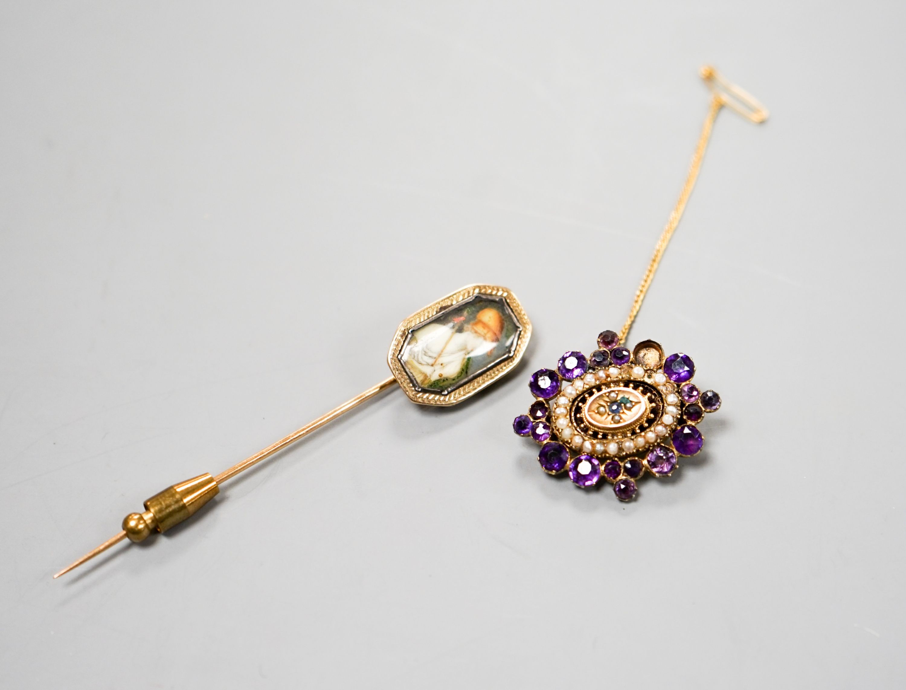 A Victorian yellow metal, amethyst and split pearl set brooch, 31mm and a stick pin.